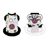 Dress with ruffle accents on the shoulders and girly ruffle skirt in a dog friendly pattern that shows a multi-colored New Years ball, the words Mommy's Midnight Kiss, a clock, champagne bottle and champagne toast, fireworks, confetti and more on a white background. It's complete with black trim on the neck and ruffles, as well as a coordinating trim under the shoulder ruffles in NYE Ball.