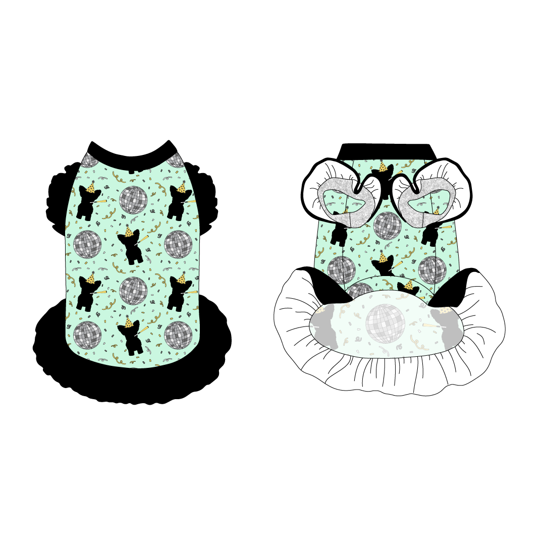 Dress with ruffle accents on the shoulders and girly ruffle skirt in a dog friendly pattern that shows a mirror ball, dog with a party blower and confetti on a light green background. It's complete with black trim on the neck and ruffles, as well as a coordinating trim under the shoulder ruffles in silver sparkle.