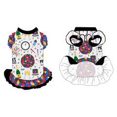 Dress with ruffle accents on the shoulders and girly double ruffle skirt in a dog friendly pattern that shows a multi-colored New Years ball, the words Mommy's Midnight Kiss, a clock, champagne bottle and champagne toast, fireworks, confetti and more on a white background. It's complete with black trim on the neck, black ruffles on the shoulders, a NYE Ball asymmetrical ruffle on top of a black ruffle skirt, as well as a coordinating trim under the shoulder ruffles in NYE Ball.