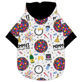 Hoodie in a dog friendly pattern that shows a multi-colored New Years ball, the words Mommy's Midnight Kiss, a clock, champagne bottle and champagne toast, fireworks, confetti and more on a white background. It's complete with a hood lined in black. Black trim is on the waist and sleeves