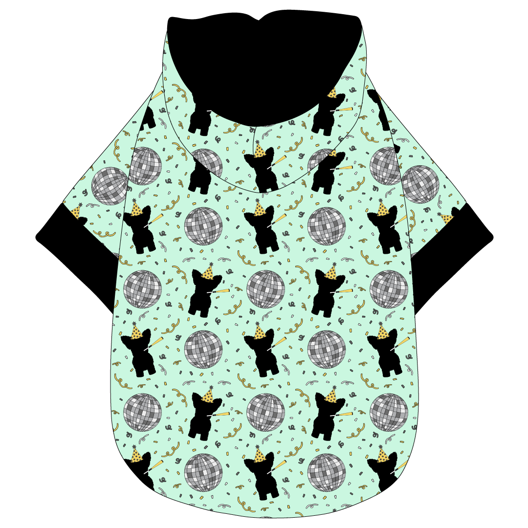 Hoodie in a dog friendly pattern that shows a mirror ball, dog with a party blower and confetti on a light green background. It's complete with a hood lined in black. Black trim is on the waist and sleeves