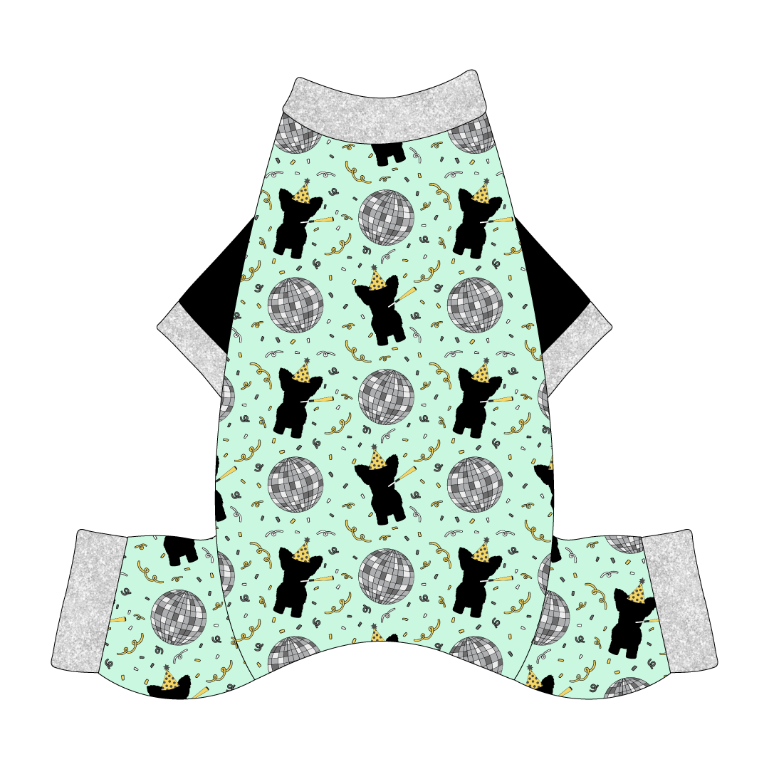 Comfy New Years Pajamas with solid black sleeves in a dog friendly pattern that shows a mirror ball, dog with a party blower and confetti on a light green background. It's complete with silver sparkle trim on the neck, sleeves and legs.