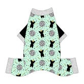 Comfy New Years Pajamas with solid black sleeves in a dog friendly pattern that shows a mirror ball, dog with a party blower and confetti on a light green background. It's complete with silver sparkle trim on the neck, sleeves and legs.
