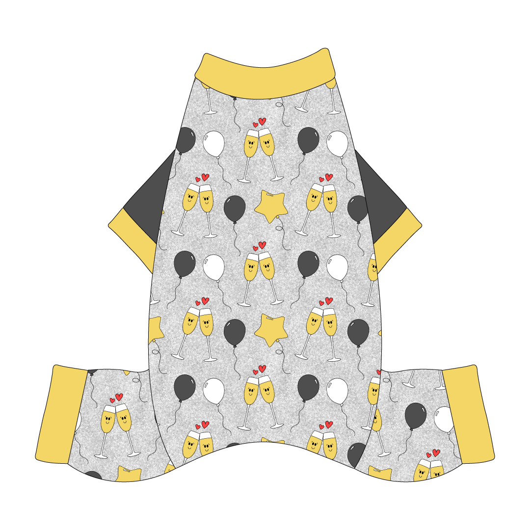Comfy New Years Pajamas with solid gray sleeves in a dog friendly pattern that shows two happy champagne glasses making a toast with hearts overhead, gold star balloons and traditional balloons in white and gray on a silver sparkle background. It's complete with gold trim on the neck, sleeves and legs.