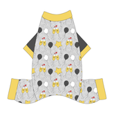 Comfy New Years Pajamas with solid gray sleeves in a dog friendly pattern that shows two happy champagne glasses making a toast with hearts overhead, gold star balloons and traditional balloons in white and gray on a silver sparkle background. It's complete with gold trim on the neck, sleeves and legs.