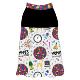 Tank style in a dog friendly pattern that shows a multi-colored New Years ball, the words Mommy's Midnight Kiss, a clock, champagne bottle and champagne toast, fireworks, confetti and more on a white background. It's complete with solid black on the upper back and gathering at the yoke. NYE Ball trim is on the neck and shoulders.