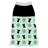 Tank style in a dog friendly pattern that shows a mirror ball, dog with a party blower and confetti on a light green background. It's complete with solid black on the upper back and gathering at the yoke. Silver sparkle trim is on the neck and shoulders.