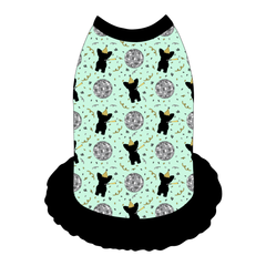 Dress style tank with a girly ruffle skirt in a dog friendly pattern that shows a mirror ball, dog with a party blower and confetti on a light green background. It's complete with black trim on the neck, shoulders and ruffles.