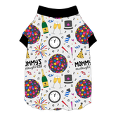 Tee shirt with flutter hem in a dog friendly pattern that shows a multi-colored New Years ball, the words Mommy's Midnight Kiss, a clock, champagne bottle and champagne toast, fireworks, confetti and more on a white background. It's complete with black trim on the neck and sleeves.