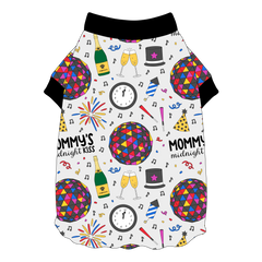 Tee shirt with flutter hem in a dog friendly pattern that shows a multi-colored New Years ball, the words Mommy's Midnight Kiss, a clock, champagne bottle and champagne toast, fireworks, confetti and more on a white background. It's complete with black trim on the neck and sleeves.