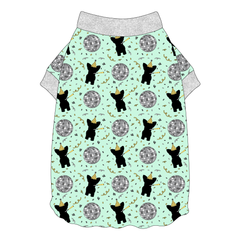 Tee shirt with flutter hem in a dog friendly pattern that shows a mirror ball, dog with a party blower and confetti on a light green background. It's complete with silver sparkle trim on the neck and sleeves.