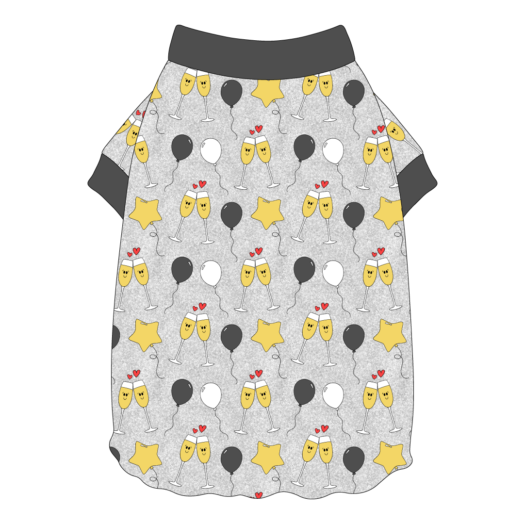 Tee shirt with flutter hem in a dog friendly pattern that shows two happy champagne glasses making a toast with hearts overhead, gold star balloons and traditional balloons in white and gray on a silver sparkle background. It's complete with gray trim on the neck and sleeves.