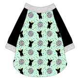 Raglan style tee in a dog friendly pattern that shows a mirror ball, dog with a party blower and confetti on a light green background. It's complete with black sleeves and trimmed in silver sparkle. Silver sparkle trim is also on the neck and waist.