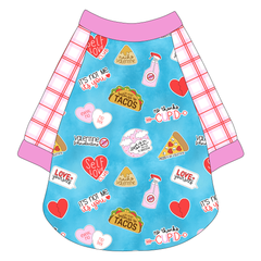 Raglan style tee in a dog friendly pattern that shows witty anti-Valentine phrases and fun images. It's complete with red and pink plaid sleeves, with solid pink trim on the sleeve edges, neck and waist.