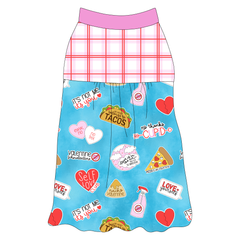 Tank style in a dog friendly pattern that shows witty anti-Valentine phrases and fun images. It's complete with red and pink plaid on the upper back and gathering at the yoke. Solid pink trim is on the neck and shoulders.