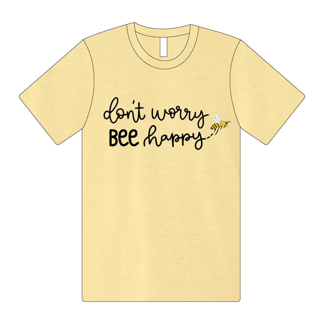 The Bella + Canvas Unisex Tee comes in Pale Yellow. In black lettering, it reads "Don't Worry Bee Happy".