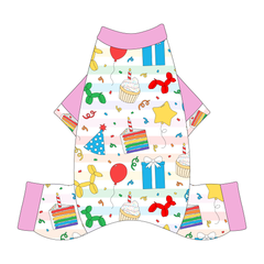 Comfy Pajamas with solid pink sleeves and a dog friendly pattern that shows party images like balloons, cake, gifts, party hats and more. It's complete with Pawty Time trim on the sleeves and solid pink trim on the neck and legs.