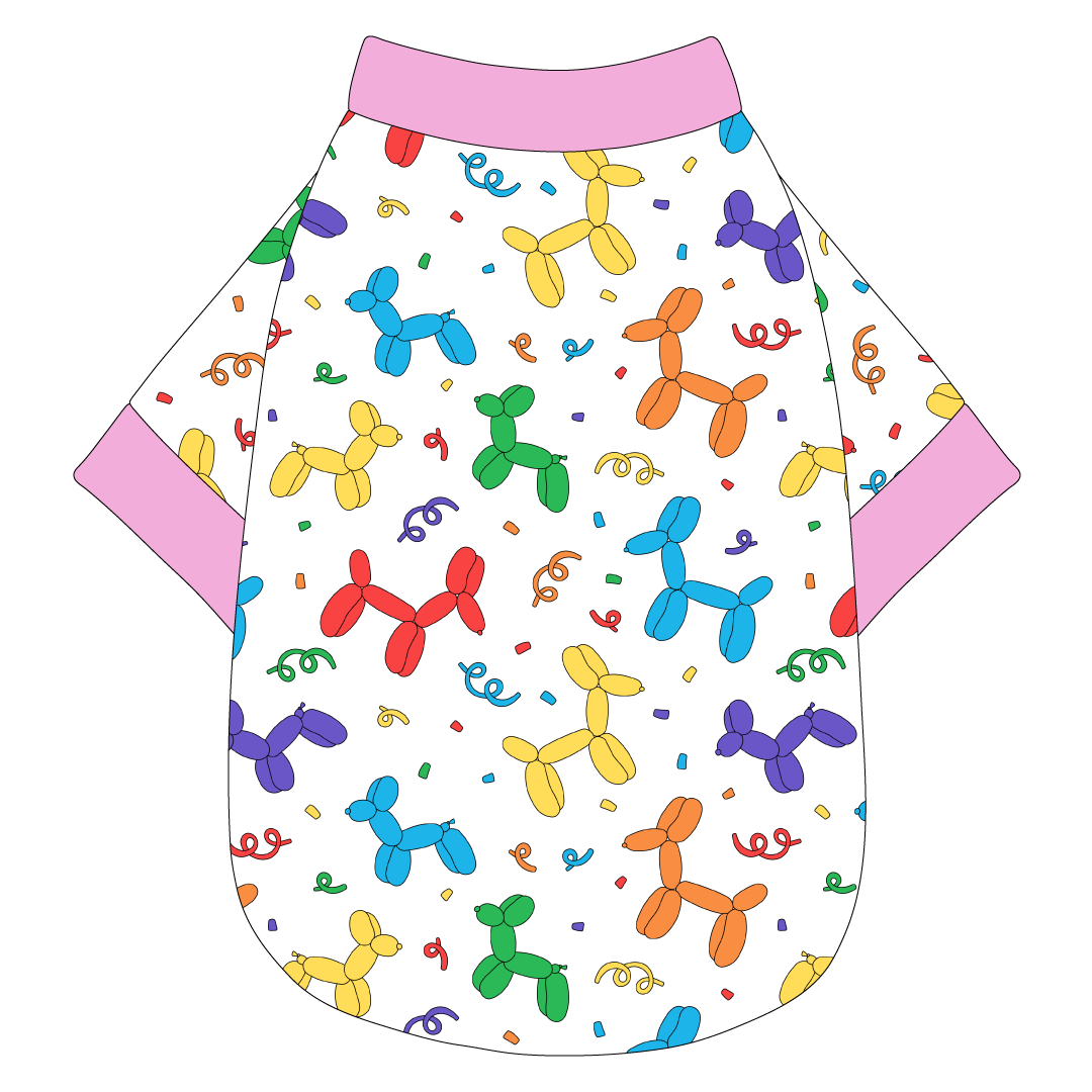 Tee shirt in a dog friendly pattern that shows party images like balloons and confetti. It's complete with solid pink trim on the neck, waist and sleeves.