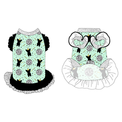 Dress with ruffle accents on the shoulders and girly double ruffle skirt in a dog friendly pattern that shows a mirror ball, dog with a party blower and confetti on a light green background.  It's complete with silver sparkle trim on the neck, black ruffles on the shoulders, a black asymmetrical ruffle on top of a silver sparkle ruffle skirt, as well as a coordinating trim under the shoulder ruffles in silver sparkle.