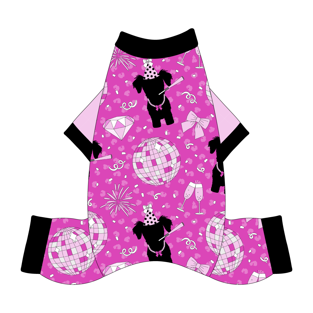 Comfy Christmas Pajamas with solid light pink sleeves and a dog friendly pattern that shows a girl dog with hat and necklace, along with a mirror ball, champagne glasses, fireworks and confetti on a magenta cheetah print background. It's complete with black trim on the neck, sleeves and waist.