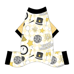 Comfy New Years Pajamas with gold sparkle sleeves in a dog friendly pattern that shows a mirror ball, top hat, champagne toast, balloons, clock striking midnight, banner reading Happy New Year and more on a light gold and white diamond background.  It's complete with black trim on the neck, sleeves and legs.