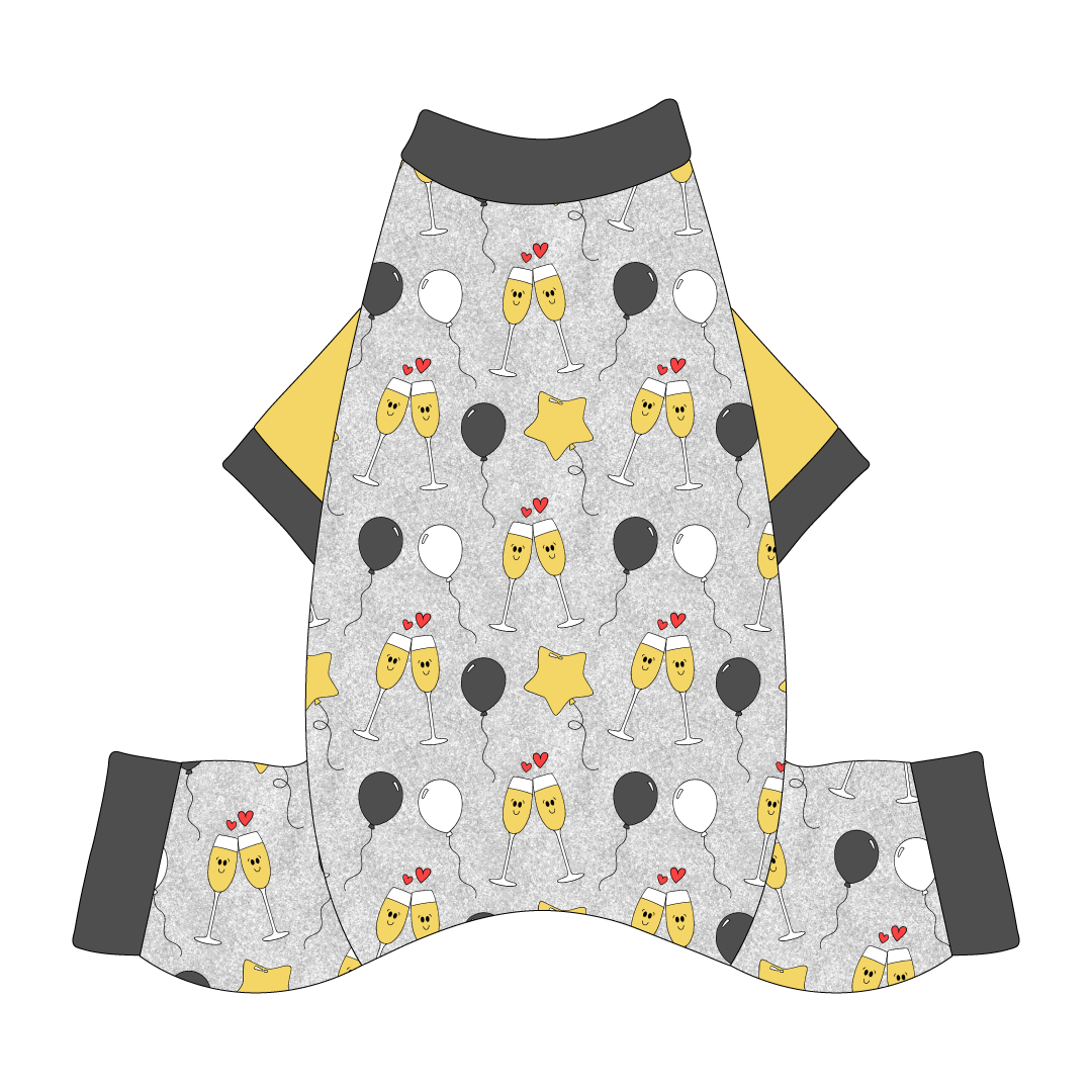 Comfy New Years Pajamas with solid gold sleeves in a dog friendly pattern that shows two happy champagne glasses making a toast with hearts overhead, gold star balloons and traditional balloons in white and gray on a silver sparkle background.  It's complete with gray trim on the neck, sleeves and legs.