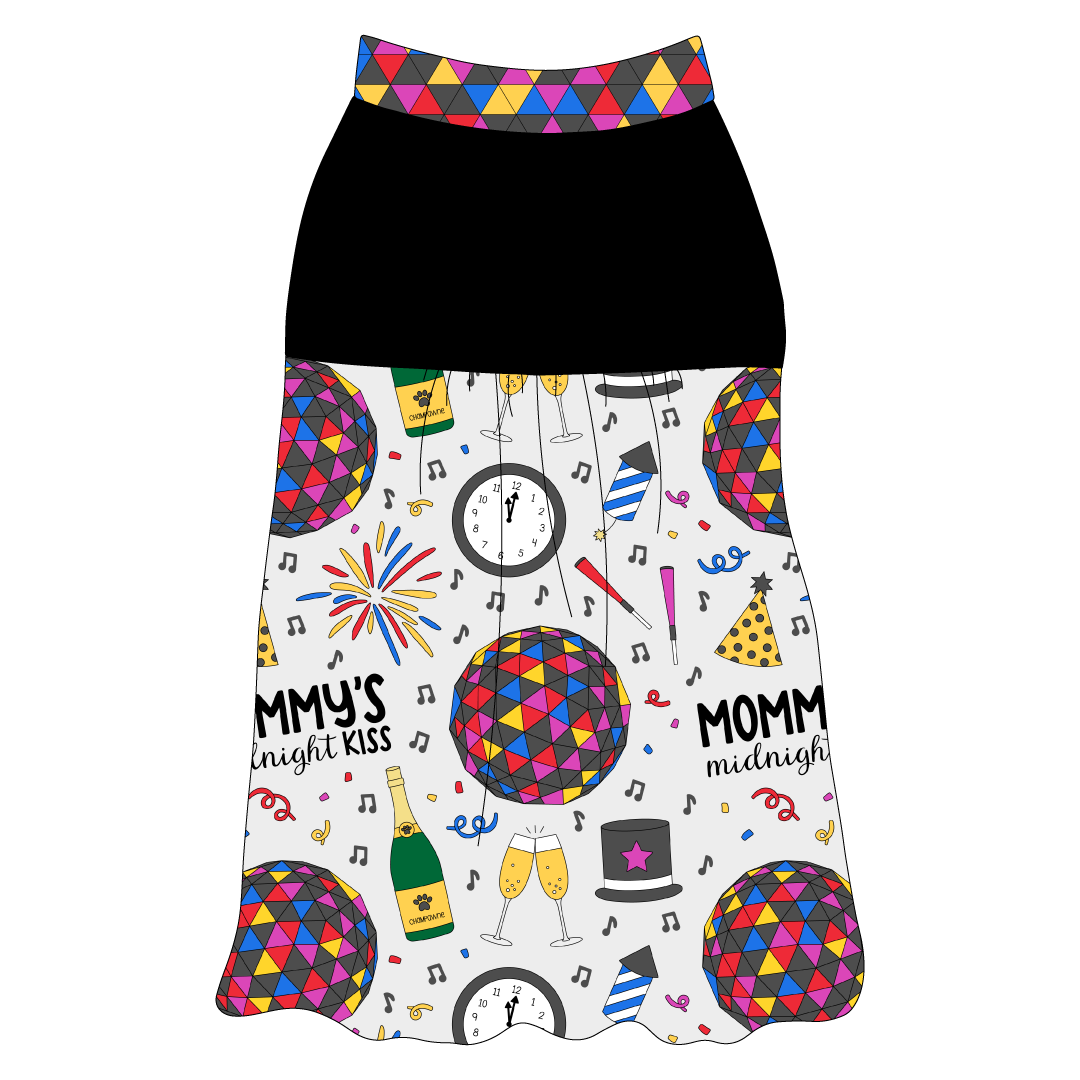 Tank style in a dog friendly pattern that shows a multi-colored New Years ball, the words Mommy's Midnight Kiss, a clock, champagne bottle and champagne toast, fireworks, confetti and more on a white background.  It's complete with solid black on the upper back and gathering at the yoke. NYE Ball trim is on the neck and shoulders.