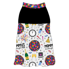 Tank style in a dog friendly pattern that shows a multi-colored New Years ball, the words Mommy's Midnight Kiss, a clock, champagne bottle and champagne toast, fireworks, confetti and more on a white background.  It's complete with solid black on the upper back and gathering at the yoke. NYE Ball trim is on the neck and shoulders.