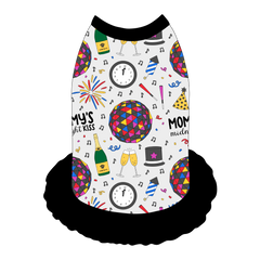 Dress style tank with a girly ruffle skirt in a dog friendly pattern that shows a multi-colored New Years ball, the words Mommy's Midnight Kiss, a clock, champagne bottle and champagne toast, fireworks, confetti and more on a white background.  It's complete with black trim on the neck, shoulders and ruffles.