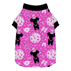 Tee shirt style with flutter hem in a dog friendly pattern that shows a girl dog with hat and necklace, along with a mirror ball, champagne glasses, fireworks and confetti on a magenta cheetah print background. It's complete with black trim on the neck and sleeves.