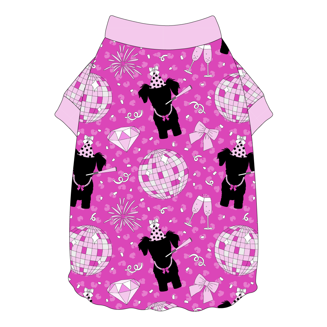 Tee shirt style with flutter hem in a dog friendly pattern that shows a girl dog with hat and necklace, along with a mirror ball, champagne glasses, fireworks and confetti on a magenta cheetah print background. It's complete with light pink trim on the neck and sleeves.