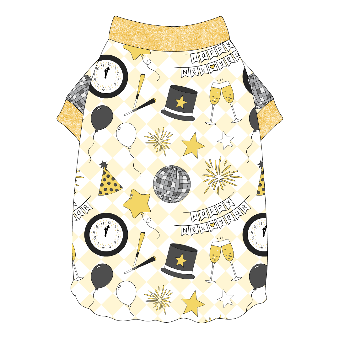 Tee shirt with flutter hem in a dog friendly pattern that shows a mirror ball, top hat, champagne toast, balloons, clock striking midnight, banner reading Happy New Year and more on a light gold and white diamond background.  It's complete with gold sparkle trim on the neck and sleeves.