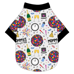 Tee shirt in a dog friendly pattern that shows a multi-colored New Years ball, the words Mommy's Midnight Kiss, a clock, champagne bottle and champagne toast, fireworks, confetti and more on a white background.  It's complete with black trim on the neck, waist and sleeves