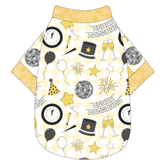 Tee shirt in a dog friendly pattern that shows a mirror ball, top hat, champagne toast, balloons, clock striking midnight, banner reading Happy New Year and more on a light gold and white diamond background.  It's complete with gold sparkle trim on the neck, waist and sleeves