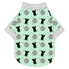 Tee shirt in a dog friendly pattern that shows a mirror ball, dog with a party blower and confetti on a light green background.  It's complete with silver sparkle trim on the neck, waist and sleeves