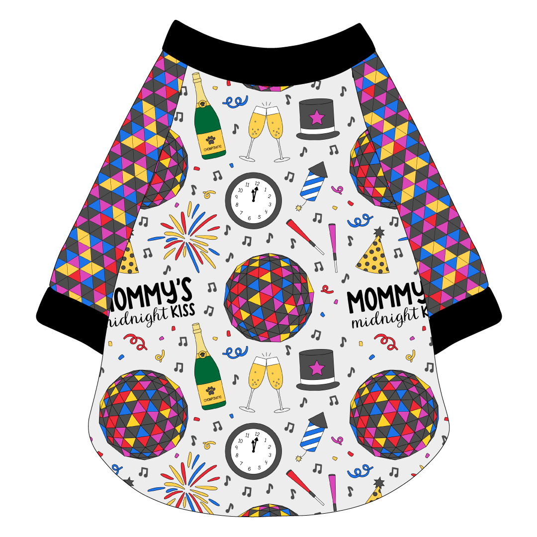 Raglan style tee in a dog friendly pattern that shows a multi-colored New Years ball, the words Mommy's Midnight Kiss, a clock, champagne bottle and champagne toast, fireworks, confetti and more on a white background.  It's complete with NYE Ball sleeves and trimmed in black. Black trim is also on the neck and waist.