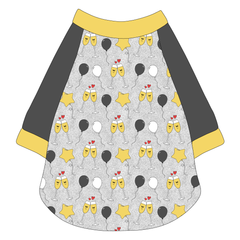 Raglan style tee in a dog friendly pattern that shows two happy champagne glasses making a toast with hearts overhead, gold star balloons and traditional balloons in white and gray on a silver sparkle background.  It's complete with gray sleeves and trimmed in gold. Gold trim is also on the neck and waist.