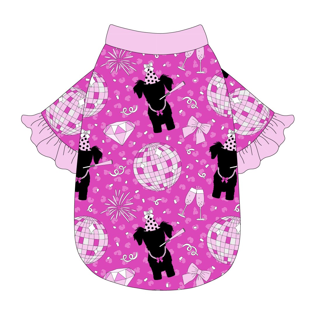 Tee style in a dog friendly pattern that shows a girl dog with hat and necklace, along with a mirror ball, champagne glasses, fireworks and confetti on a magenta cheetah print background. It's complete with light pink ruffles on the sleeve edges. Light pink trim is also on the neck and waist.