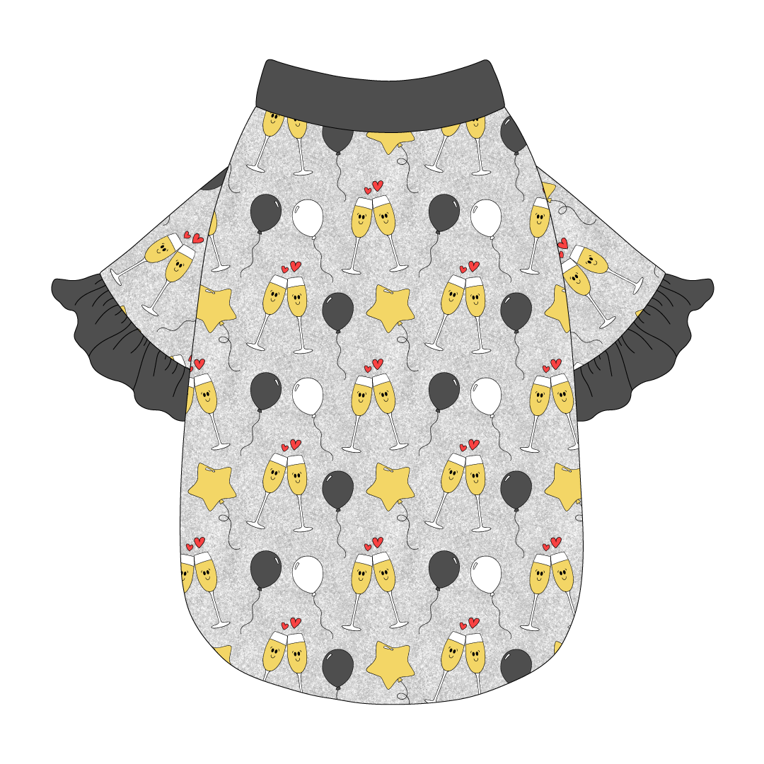 Tee style in a dog friendly pattern that shows two happy champagne glasses making a toast with hearts overhead, gold star balloons and traditional balloons in white and gray on a silver sparkle background. It's complete with gray ruffles on the sleeve edges. Gray trim is also on the neck and waist.