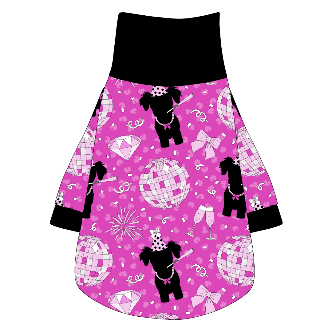 Tee shirt with turtleneck in a dog friendly pattern that shows a girl dog with hat and necklace, along with a mirror ball, champagne glasses, fireworks and confetti on a magenta cheetah print background. It's complete with black trim on the neck, sleeves and waist.