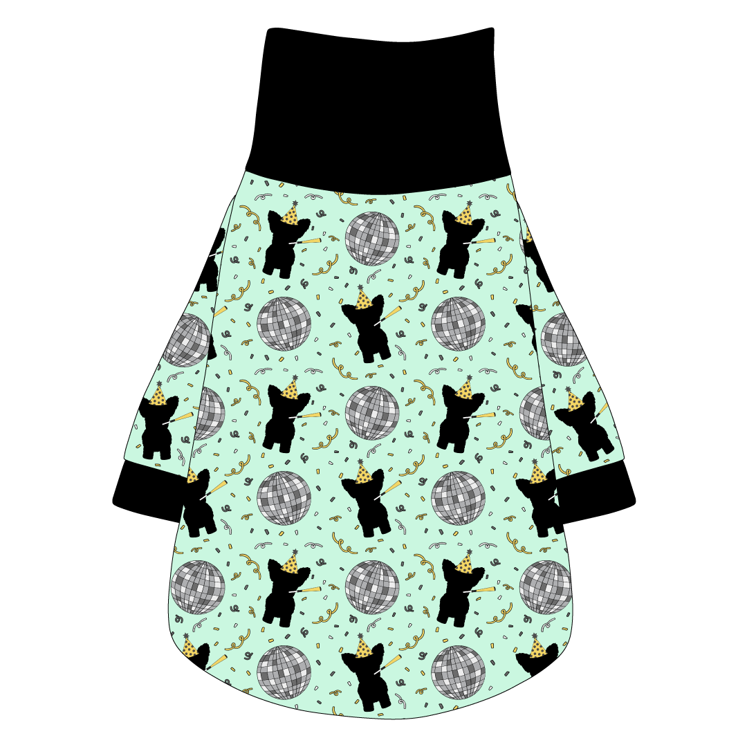 Tee shirt with turtleneck in a dog friendly pattern that shows a mirror ball, dog with a party blower and confetti on a light green background.  It's complete with black trim on the neck, waist and sleeves.