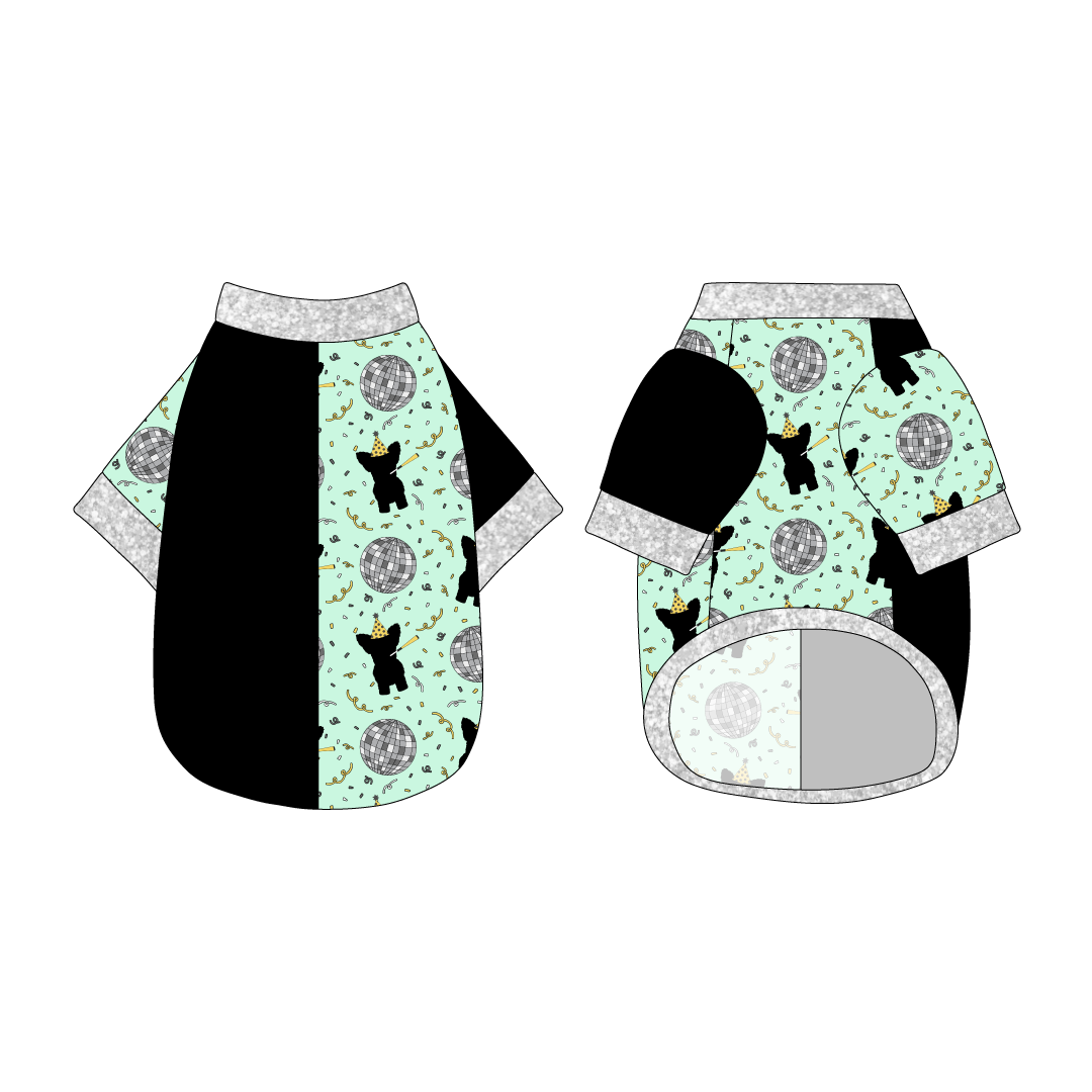 Split back tee shirt using two coordinating fabrics: one side in solid black and one side in a dog friendly pattern that shows a mirror ball, dog with a party blower and confetti on a light green background.  It's complete with silver sparkle trim on the neck, sleeves and waist.