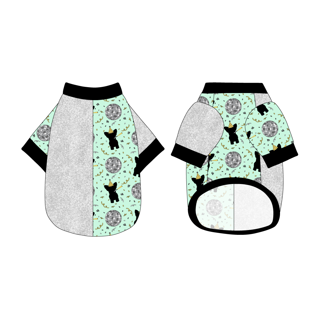 Split back tee shirt using two coordinating fabrics: one side in silver sparkle and one side in a dog friendly pattern that shows a mirror ball, dog with a party blower and confetti on a light green background.  It's complete with black trim on the neck, sleeves and waist.