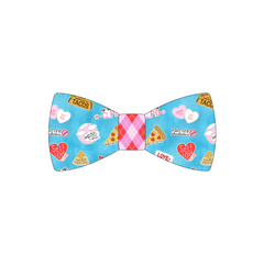 Bowtie in a dog friendly pattern that shows witty anti-Valentine phrases and fun images. The center is made from Valentine argyle plaid trim. It's complete with attached elastic loops on the back to secure on dog collar.