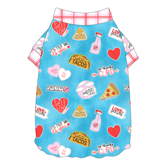 Tee shirt style with flutter hem in a dog friendly pattern that shows witty anti-Valentine phrases and fun images. It's complete with red and pink plaid trim on the neck and sleeves.