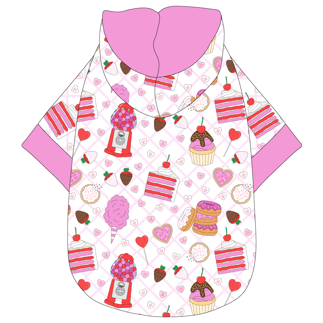 Hoodie in a dog friendly pattern that shows a variety of sweet treats. It's complete with a hood lined in solid pink trim, which is also found on the sleeve edges and waist.