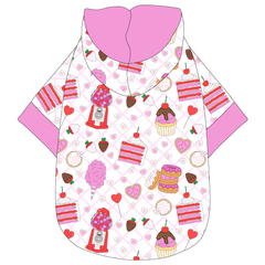 Hoodie in a dog friendly pattern that shows a variety of sweet treats. It's complete with a hood lined in solid pink trim, which is also found on the sleeve edges and waist.