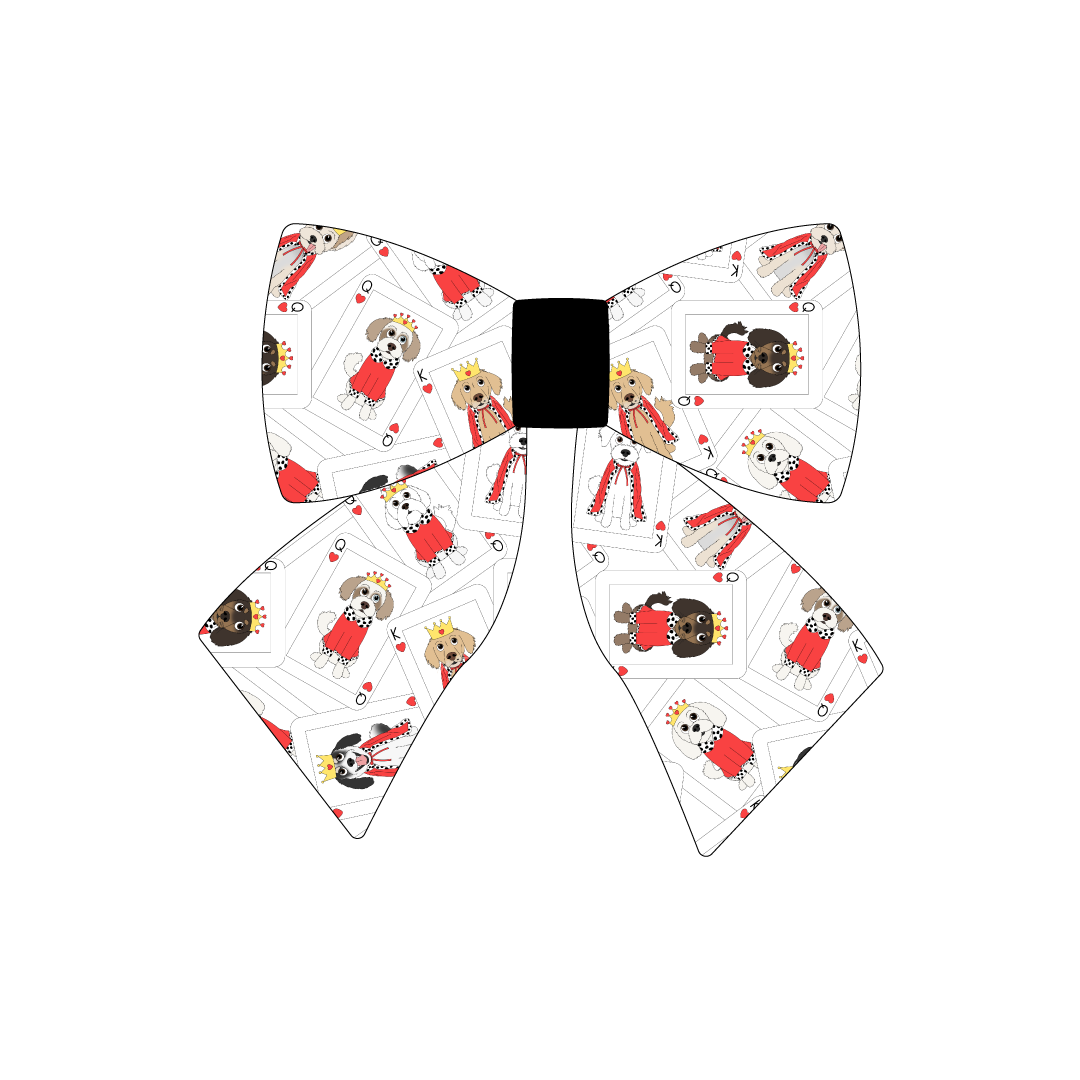 Sailor Bow in a dog friendly pattern that shows boy and girl dogs dressed as kings and queens on playing cards. The center is made from solid black trim. It's complete with attached elastic loops on the back to secure on dog collar.