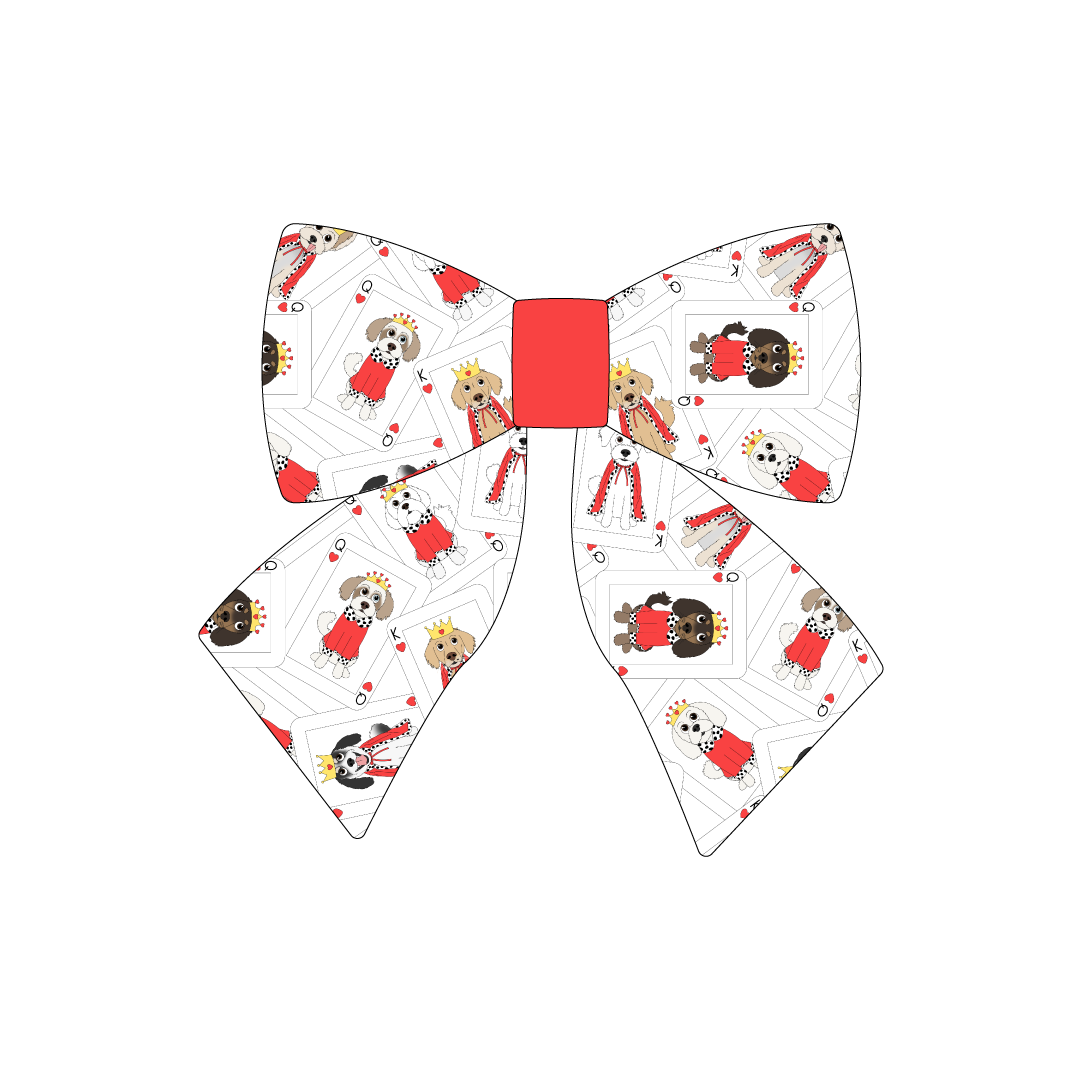 Sailor Bow in a dog friendly pattern that shows boy and girl dogs dressed as kings and queens on playing cards. The center is made from solid red trim. It's complete with attached elastic loops on the back to secure on dog collar.