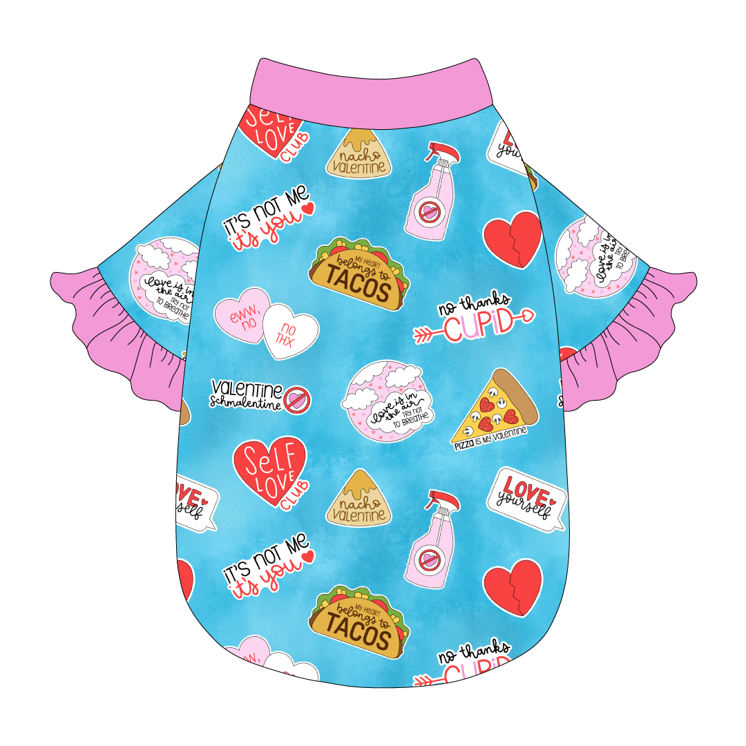 Tee style in a dog friendly pattern that shows witty anti-Valentine phrases and fun images. It's complete with solid pink ruffles on the sleeve edges, as well as trim on the neck and waist.